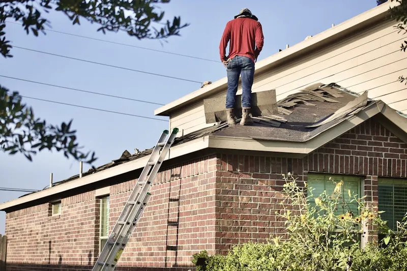Professional roofer working on a residential roof in Milwaukie Heights